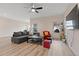 Open living room with a sectional sofa, a coffee table, and plenty of natural light at 3934 Saddle Bag Ct, Dacula, GA 30019