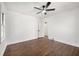 Spacious bedroom with gleaming hardwood floors, ceiling fan, and white walls at 1951 Cummings Sw Dr, Atlanta, GA 30311