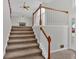 Carpeted staircase with wooden railing leading to the second floor at 219 Regency Ct, Acworth, GA 30102