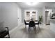 Dining area with modern table and chairs, view of backyard through double doors, near kitchen at 4001 Red Oak Dr, Atlanta, GA 30340