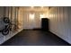 Garage interior with dark gray floor, white walls, bikes, and a refrigerator at 4001 Red Oak Dr, Atlanta, GA 30340