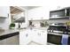 Updated kitchen boasts white cabinets, stainless steel appliances, and a granite countertop at 4001 Red Oak Dr, Atlanta, GA 30340