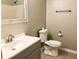 Gray bathroom vanity, white toilet, and tile flooring at 6874 Red Maple Dr, Rex, GA 30273