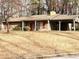 Front exterior view of a one-story home with carport and landscaping at 6874 Red Maple Dr, Rex, GA 30273