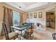 Dining room with glass-top table, chairs, and a view into the kitchen at 4027 Crossings Way, Stone Mountain, GA 30083