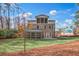 Backyard view of two-story house with screened porch and balcony at 4093 Longleaf Ln, Tucker, GA 30084