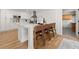 Kitchen island with bar seating, white cabinets, and hardwood floors at 4337 Lake Chimney Ne Ct, Roswell, GA 30075