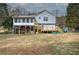 Backyard view of a two-story home with a screened porch and wooden deck at 126 Old Rudy York Nw Rd, Cartersville, GA 30121