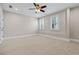 Spacious bedroom with carpeted floors and a ceiling fan at 211 Alderwood Ne Pt, Atlanta, GA 30328