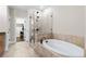 Main bathroom with soaking tub and glass shower at 211 Alderwood Ne Pt, Atlanta, GA 30328