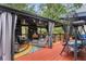 Relaxing backyard deck with covered gazebo, string lights, and outdoor furniture at 10119 Azalea Dr, Covington, GA 30014