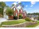 Brick two-story home with landscaped yard and retaining wall at 10119 Azalea Dr, Covington, GA 30014