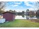 Serene lake view with storage shed and grassy area at 320 Spring Creek Dr, Stockbridge, GA 30281