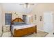 Main bedroom with king-size bed, ceiling fan, and ensuite bathroom access at 320 Spring Creek Dr, Stockbridge, GA 30281