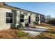 Concrete back patio with two chairs and some greenery. The house has light green siding and white trim at 325 Forkview Dr, Lawrenceville, GA 30044