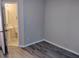 Empty bedroom with gray walls and dark wood-look laminate floors, with attached bathroom at 1040 Hillsborough Chase Nw, Kennesaw, GA 30144