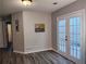 Inviting living area with wood-look floors, French doors, and neutral paint at 1040 Hillsborough Chase Nw, Kennesaw, GA 30144