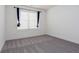 Well-lit bedroom featuring grey carpet and window with curtains at 4274 Linworth Blvd, Austell, GA 30106