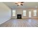 Bright living room with fireplace, wood floors, and large windows at 224 Chiswick Loop, Stockbridge, GA 30281