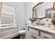 Stylish powder room with unique wallpaper and granite vanity at 370 Park Ne Pl, Atlanta, GA 30317