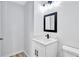 Simple bathroom with white vanity, black fixtures, and light wood-look floor at 7017 Ray St, Riverdale, GA 30274