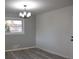 Dining room with gray walls, modern light fixture, and wood-look flooring at 1580 Hampshire Pl, Decatur, GA 30032