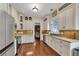 Bright, updated kitchen featuring white cabinetry, stainless steel appliances, and granite countertops at 239 Morning Mist Way, Woodstock, GA 30189