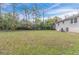 Large backyard with spacious green lawn, surrounded by trees at 2479 Brentwood Rd, Decatur, GA 30032