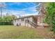 House exterior with backyard, featuring a covered patio and green lawn at 2479 Brentwood Rd, Decatur, GA 30032