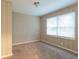 Cozy carpeted bedroom with neutral walls and window at 2479 Brentwood Rd, Decatur, GA 30032