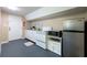 Basement kitchen with white cabinets, stainless steel appliances, and a gray floor at 5573 Prince Phillip Way, Stone Mountain, GA 30087