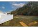 Spacious backyard with a white vinyl fence and lush trees at 6135 Smoke Ridge Ln, Cumming, GA 30041