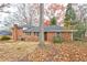 Large, fenced backyard with trees and a small patio at 2371 Oakridge Ct, Decatur, GA 30032