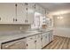 Spacious kitchen with white cabinets, granite countertops, and wood-look flooring at 2371 Oakridge Ct, Decatur, GA 30032