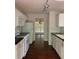 Bright kitchen with white cabinets, black countertops, and stainless steel appliances at 635 Arncliffe Ct, Johns Creek, GA 30005