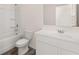 Clean bathroom with white vanity, tub, and shower at 979 Blue Juniper Cir, Loganville, GA 30052