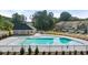 Community pool with a covered patio and surrounding fence at 358 Elgin Dr # 161, Lawrenceville, GA 30045