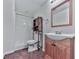 Simple basement bathroom with shower, toilet, sink, and wooden vanity at 5229 Boone Ct, Villa Rica, GA 30180