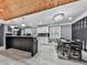 Modern kitchen with white cabinets, black island, stainless steel appliances, and dining area at 1564 Bubbling Creek Rd, Brookhaven, GA 30319