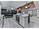 Kitchen with white cabinetry, stainless steel appliances, and island overlooking dining and living space at 1564 Bubbling Creek Rd, Brookhaven, GA 30319