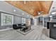 Inviting living room with wood-beamed ceiling, modern light fixtures, and stylish furniture at 1564 Bubbling Creek Rd, Brookhaven, GA 30319