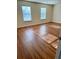 Spacious bedroom with wood-look flooring and two large windows at 3015 Carnegie Hall Ct, Cumming, GA 30040