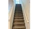 Carpeted staircase leading to the upper level with white railing and hardwood treads at 3015 Carnegie Hall Ct, Cumming, GA 30040