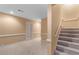 Carpeted basement stairs and doorway to another room at 1501 Annapolis Way, Grayson, GA 30017