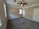 Bedroom with gray carpet, ceiling fan, and multiple doors at 941 Capitol View Ave, Atlanta, GA 30318