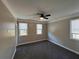 Bedroom with gray carpet, ceiling fan, and two windows at 941 Capitol View Ave, Atlanta, GA 30318