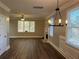 Dining room with chandelier, fireplace, and wood-look floors adjacent to the kitchen at 941 Capitol View Ave, Atlanta, GA 30318