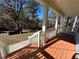 Covered front porch with wooden decking and steps leading to the landscaped yard at 941 Capitol View Ave, Atlanta, GA 30318
