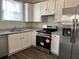 Modern kitchen with white cabinetry, stainless steel appliances, and granite countertops at 941 Capitol View Ave, Atlanta, GA 30318