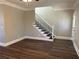 Living room with dark wood-look floors, a staircase, and neutral-colored walls at 941 Capitol View Ave, Atlanta, GA 30318
